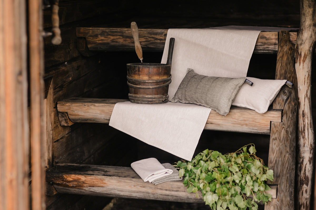 Laituri white/beige seat cover styled on a bench in a traditional Finnish sauna